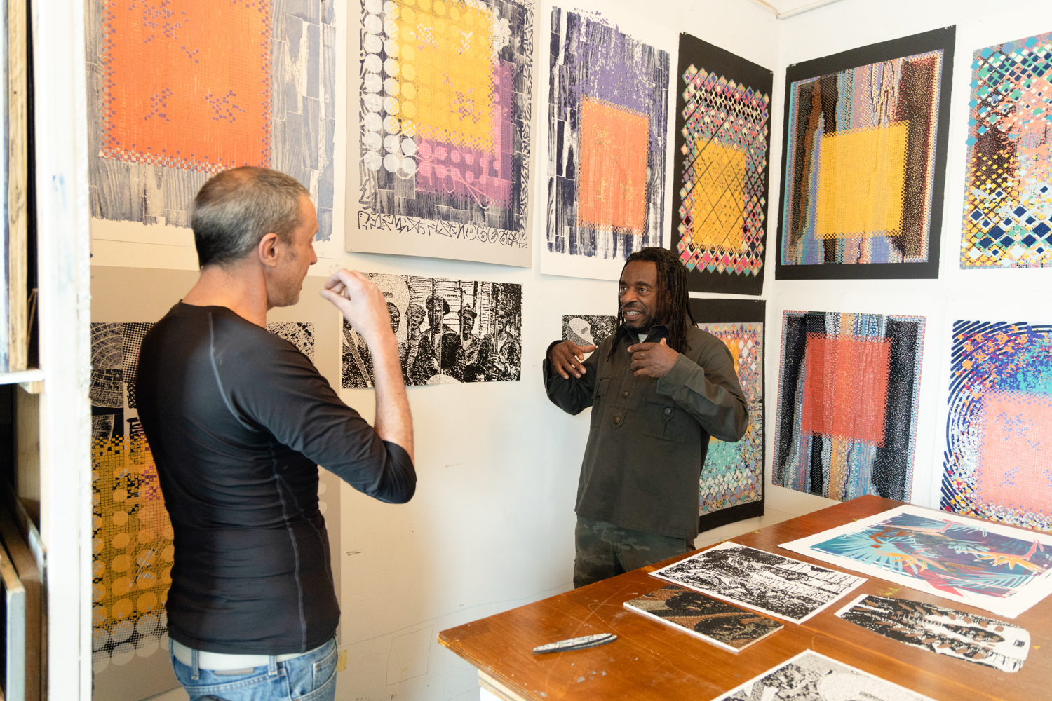Artist signing prints with a master printer in the Brandywine studio